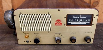 Small Xtal controlled transceiver with BC band receiver dial and tuning knob, 3 other knobs and speaker.